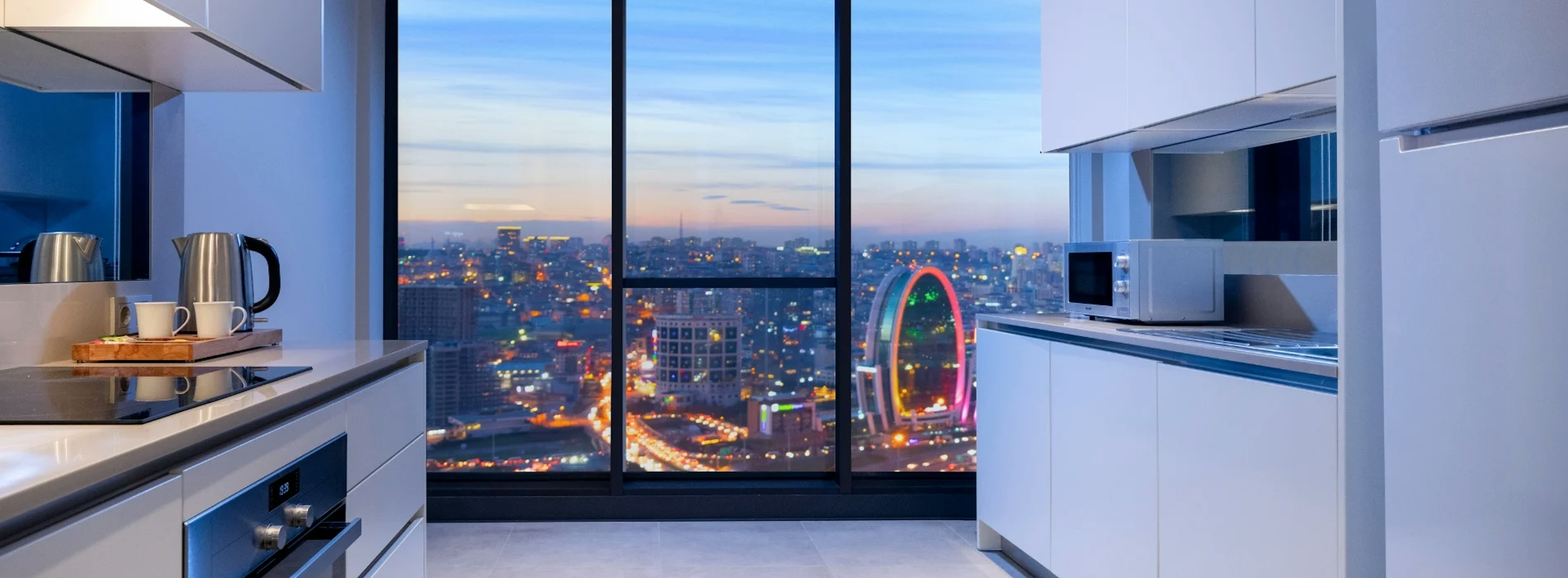 Picture of a kitchen with a big view on a city skyline