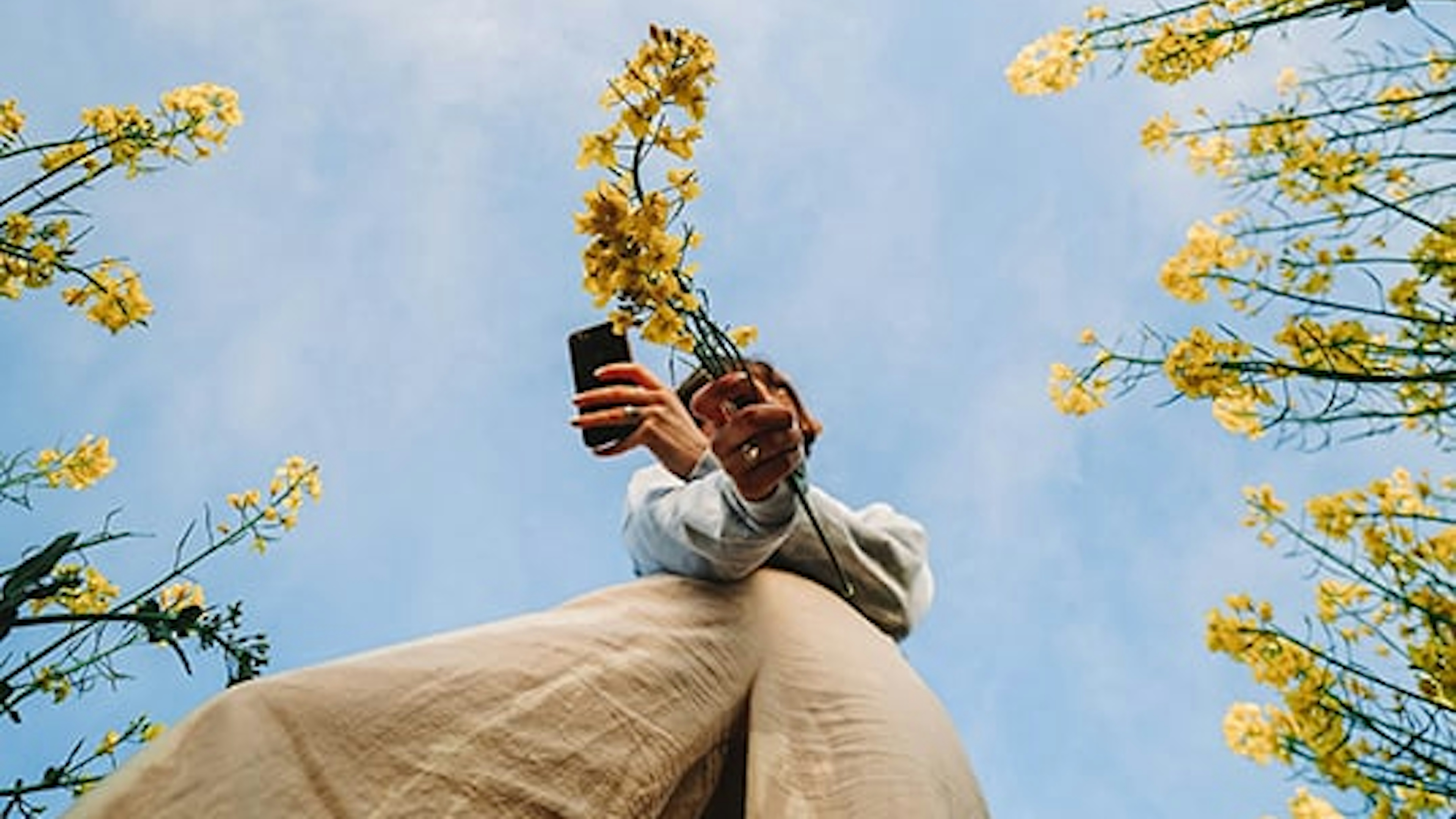 Picture of someone with flower and a phone