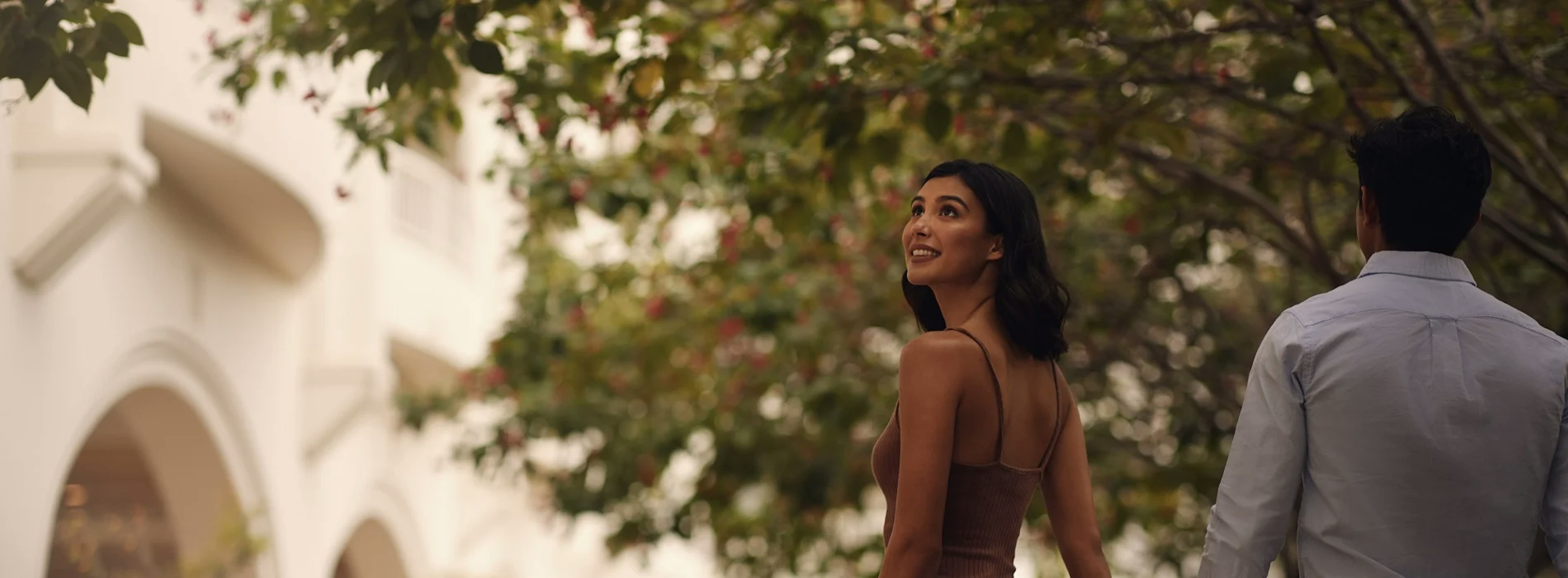 Women with a men outside looking and smiling