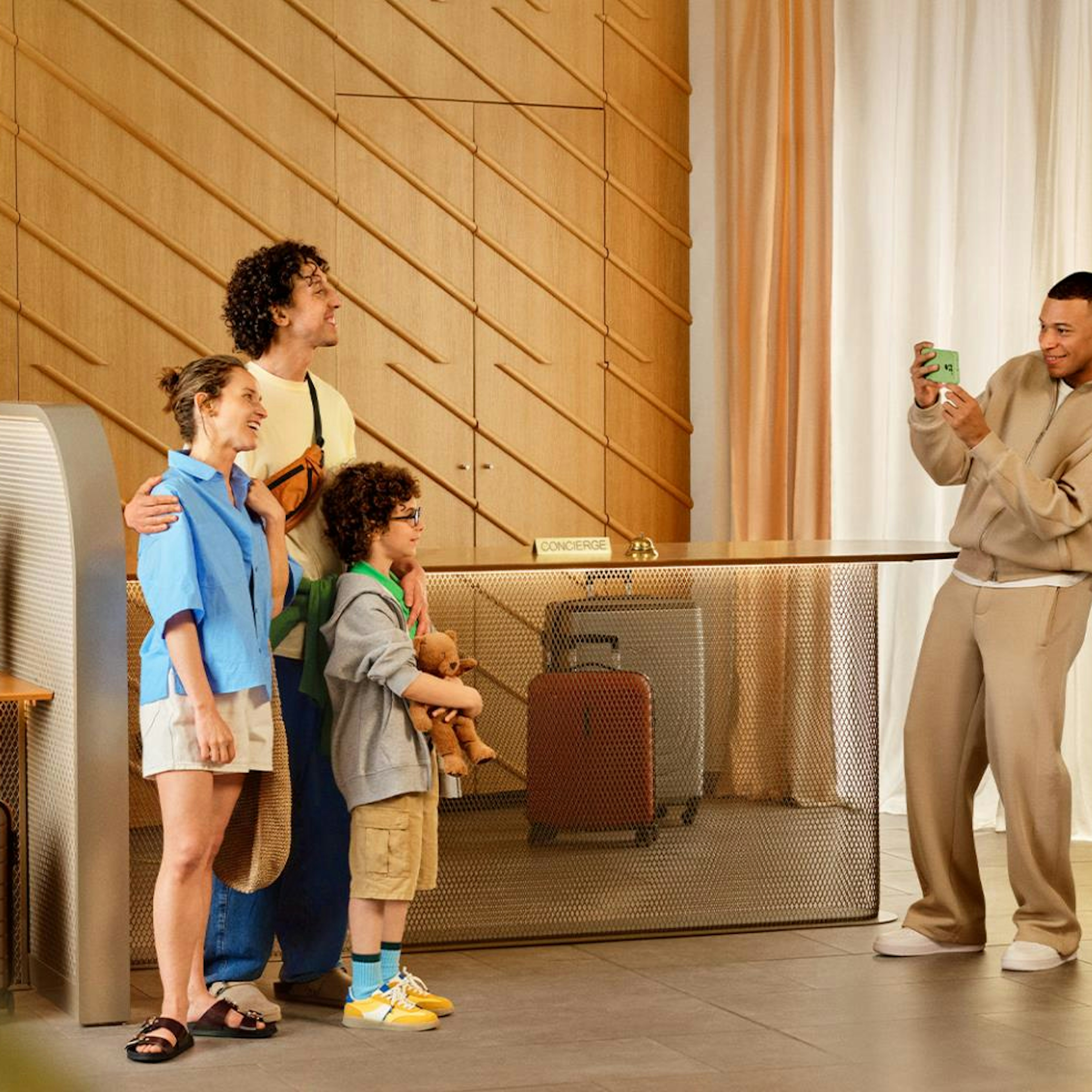 Kylian Mbappe taking picture of people in accor hotel